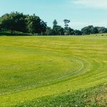 Panoramic view of a lush green golf course at Arkansas Golf Center. Smooth