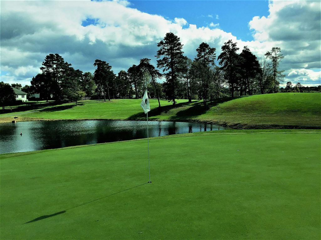 Panoramic view of a lush green golf course at Arkansas Golf Trail. Smooth