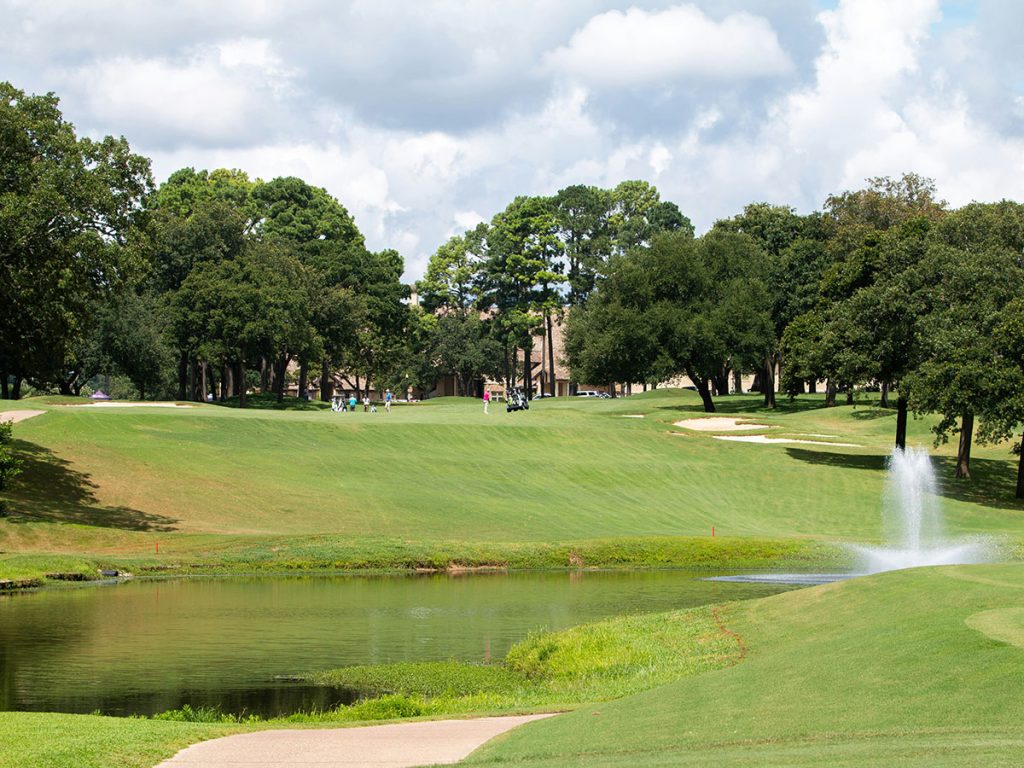 Panoramic view of a lush green golf course at Bellair Golf Park. Smooth