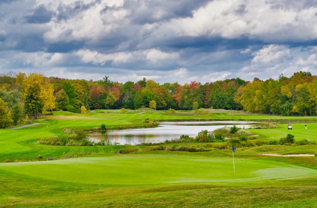 Panoramic view of a lush green golf course at Big Spring Lake Golf Club. Smooth