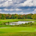 Panoramic view of a lush green golf course at Big Spring Lake Golf Club. Smooth