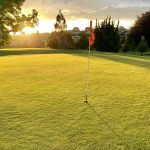 Panoramic view of a lush green golf course at Coastal Alabama Golf. Smooth