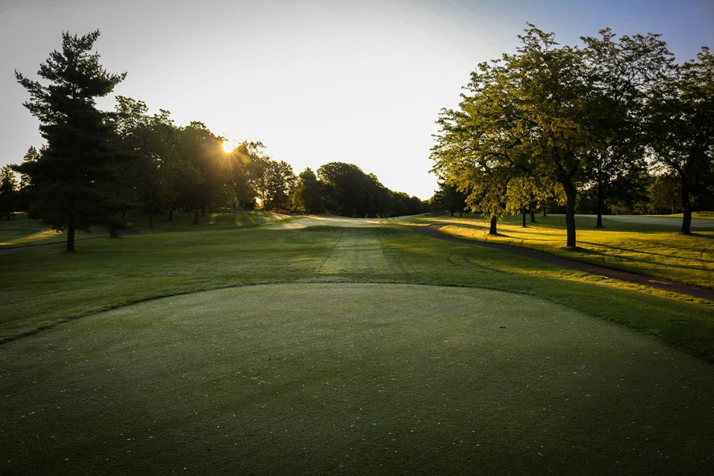 Panoramic view of a lush green golf course at Dogwood Hills Golf Course. Smooth