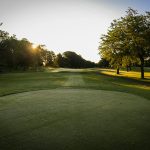 Panoramic view of a lush green golf course at Dogwood Hills Golf Course. Smooth