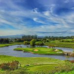 Panoramic view of a lush green golf course at Goose Pond Colony Resort. Smooth