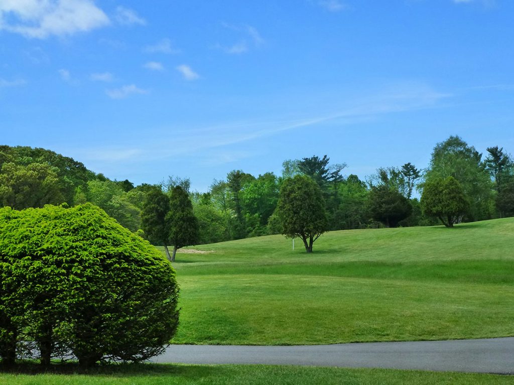 Panoramic view of a lush green golf course at Granada Golf Course. Smooth