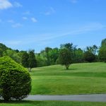 Panoramic view of a lush green golf course at Granada Golf Course. Smooth