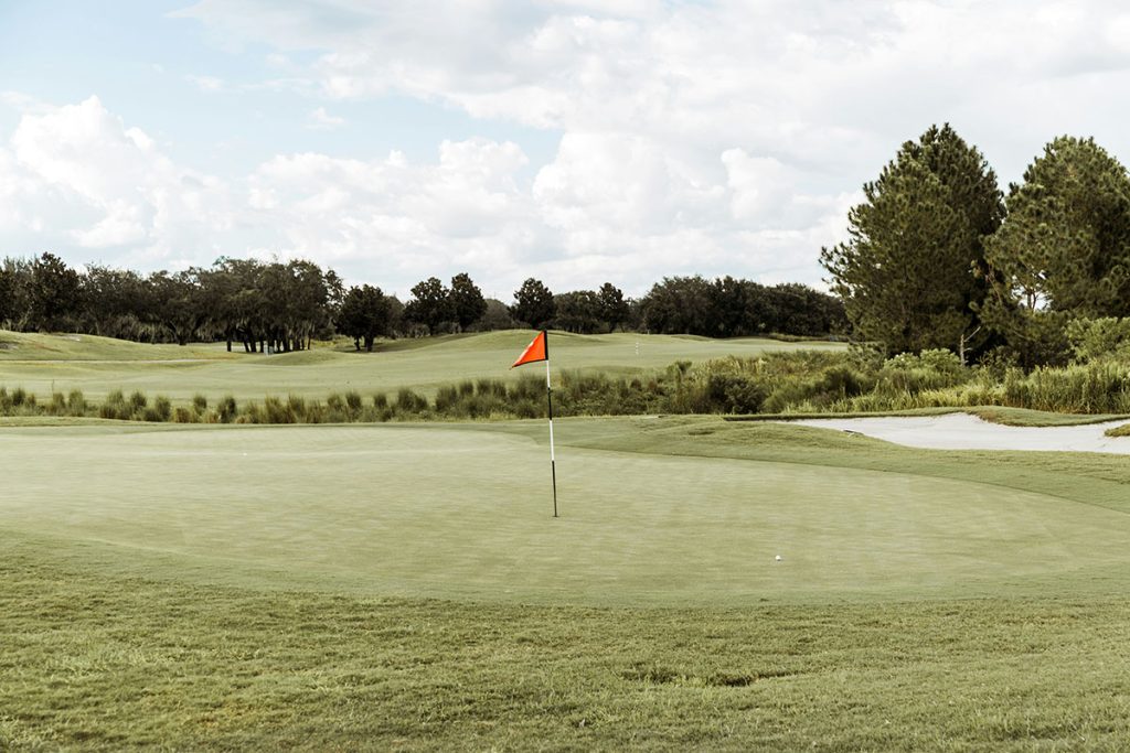 Panoramic view of a lush green golf course at Gulf Links Golf Course. Smooth