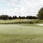 Panoramic view of a lush green golf course at Gulf Links Golf Course. Smooth