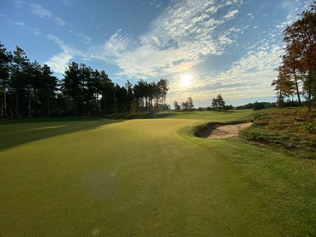 Panoramic view of a lush green golf course at Old Overton Club. Smooth