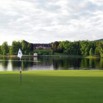 Panoramic view of a lush green golf course at Quail Creek Resort. Smooth