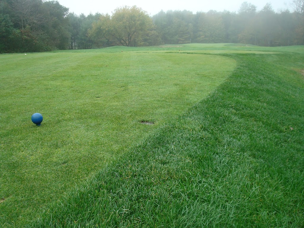 Panoramic view of a lush green golf course at Acushnet River Valley. Smooth