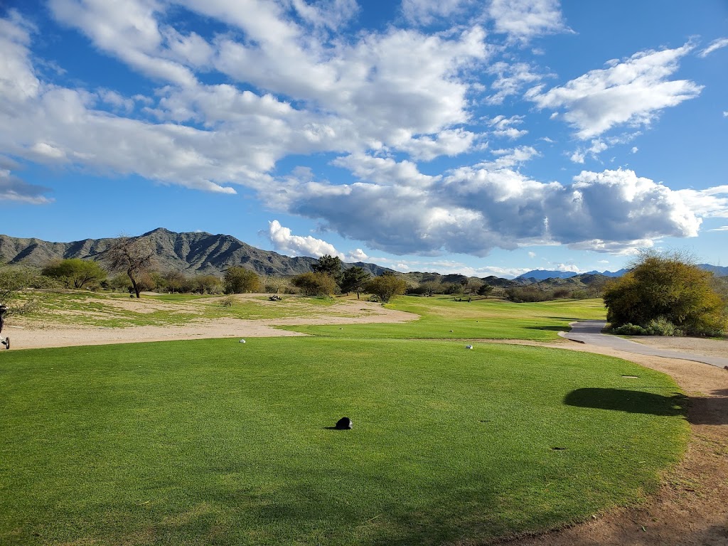 Panoramic view of a lush green golf course at Aguila Golf Course. Smooth