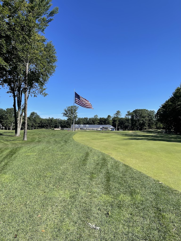 Panoramic view of a lush green golf course at American Dunes Golf Club. Smooth