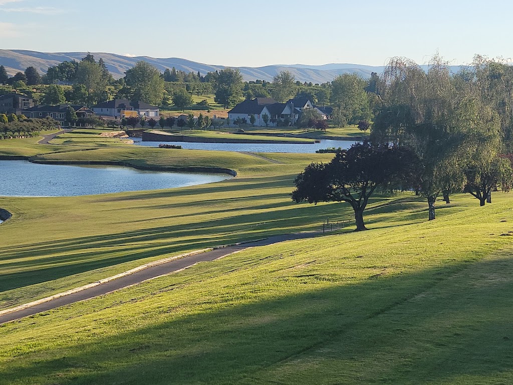 Panoramic view of a lush green golf course at Apple Tree Golf Course. Smooth