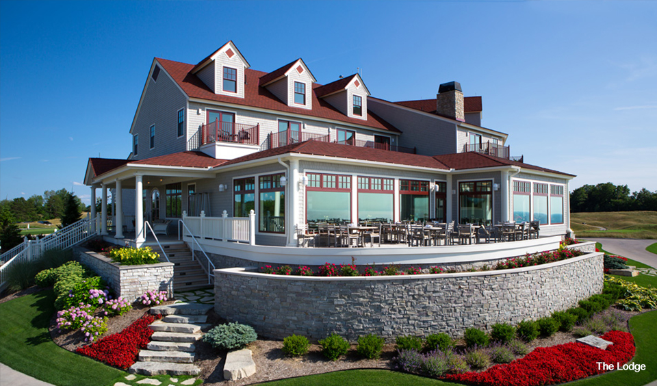 Panoramic view of a lush green golf course at Arcadia Bluffs Golf Club. Smooth