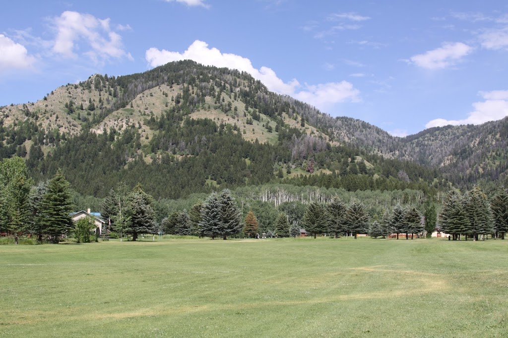 Panoramic view of a lush green golf course at Aspen Hills Golf Course. Smooth