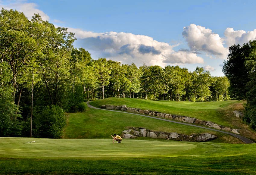 Panoramic view of a lush green golf course at Atkinson Resort & Country Club. Smooth