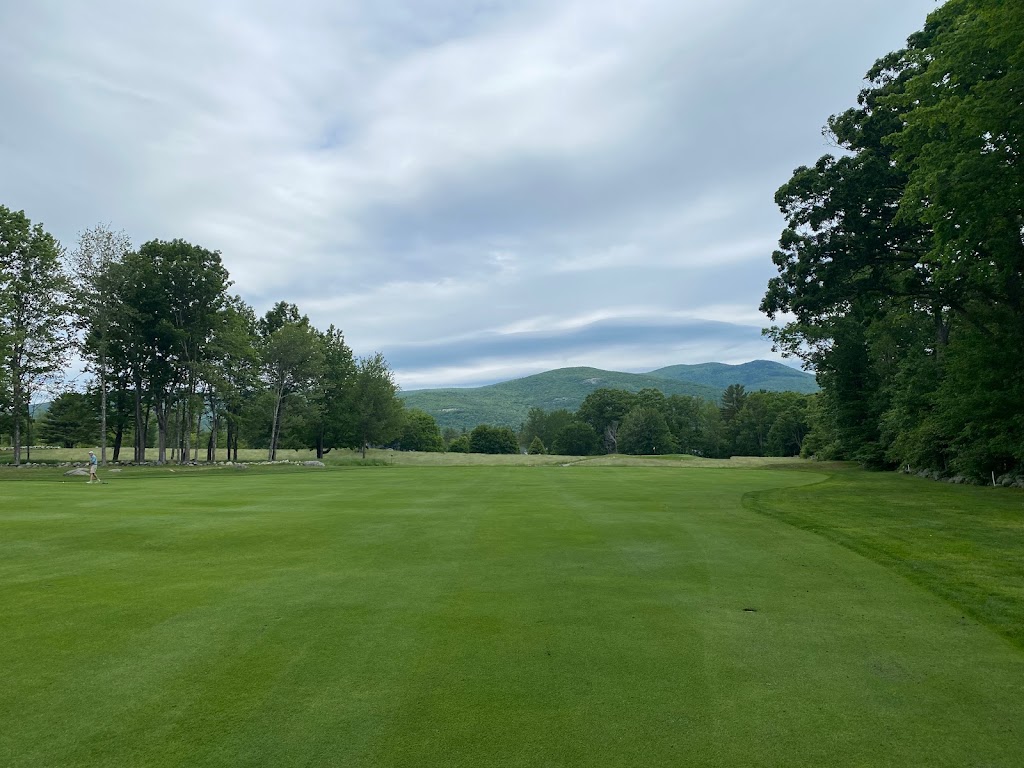 Panoramic view of a lush green golf course at Bald Peak Colony Club. Smooth