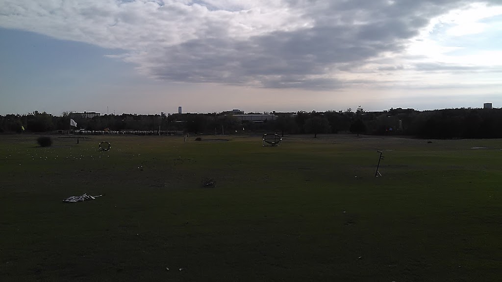 Panoramic view of a lush green golf course at Ball Golf Center. Smooth