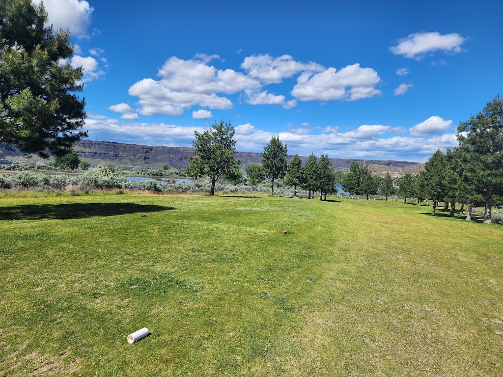 Panoramic view of a lush green golf course at Banks Lake Golf Course. Smooth