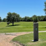 Panoramic view of a lush green golf course at Baxter Springs Golf & Country Club. Smooth