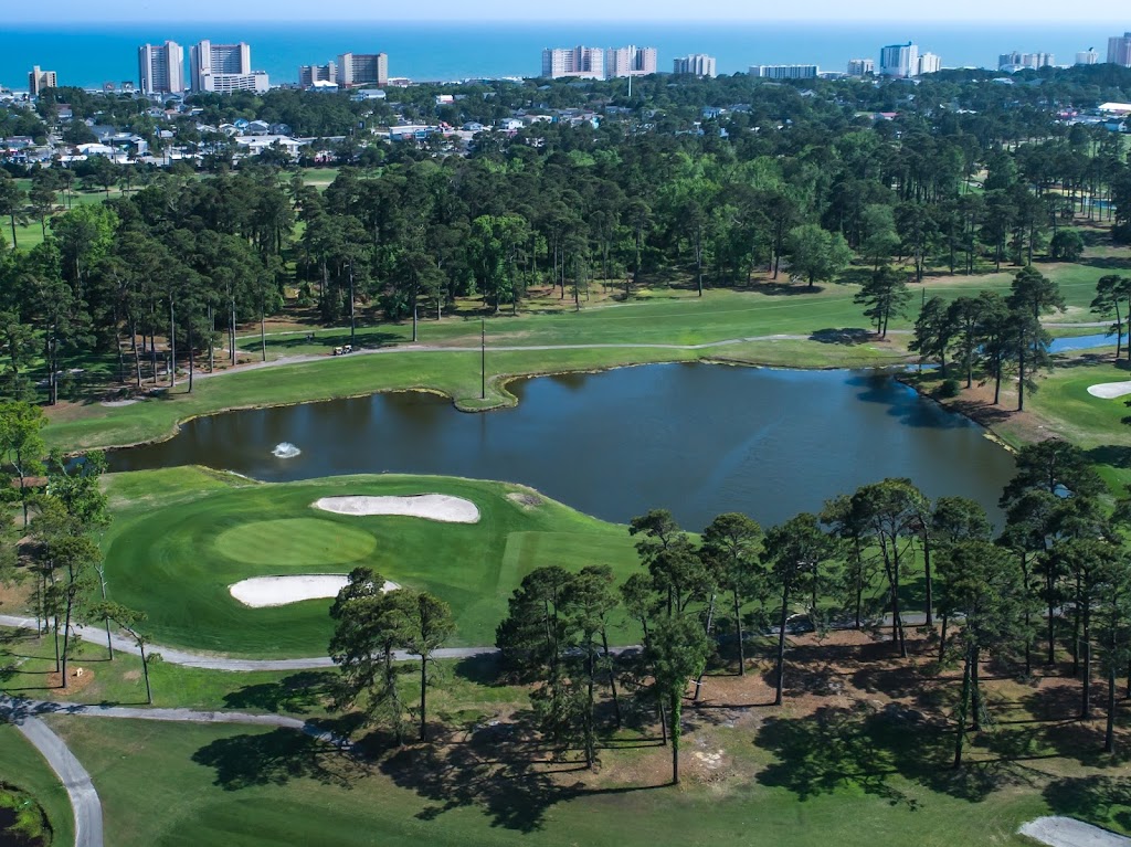 Panoramic view of a lush green golf course at Beachwood Golf Club. Smooth