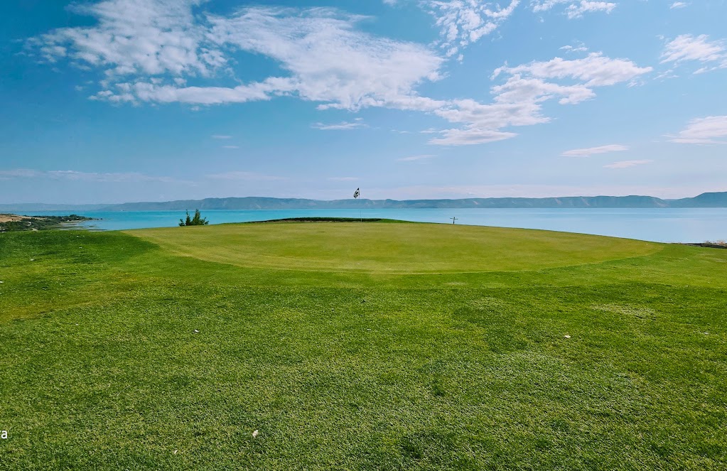 Panoramic view of a lush green golf course at Bear Lake West Golf Course. Smooth