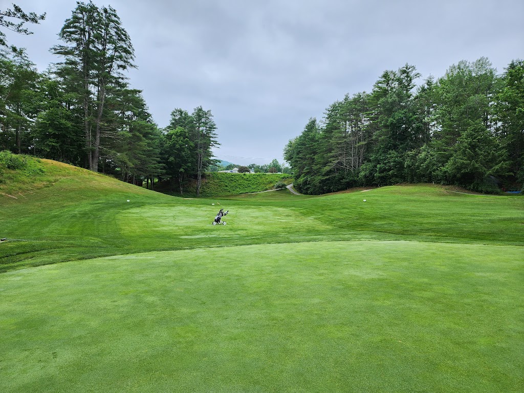 Panoramic view of a lush green golf course at Bellows Falls Country Club. Smooth