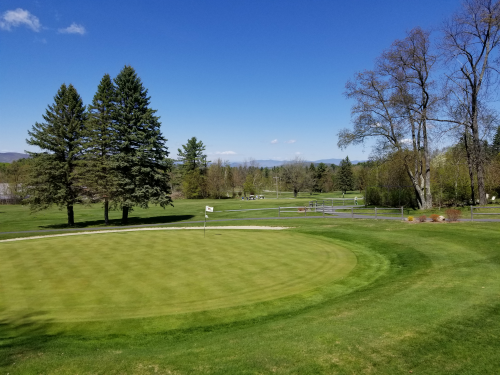 Panoramic view of a lush green golf course at Bethlehem Country Club. Smooth