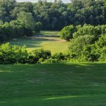 Panoramic view of a lush green golf course at Big Sugar Golf Club. Smooth