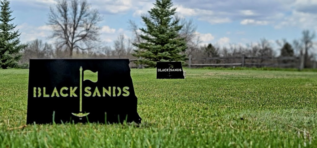 Panoramic view of a lush green golf course at Black Sands Golf Course. Smooth