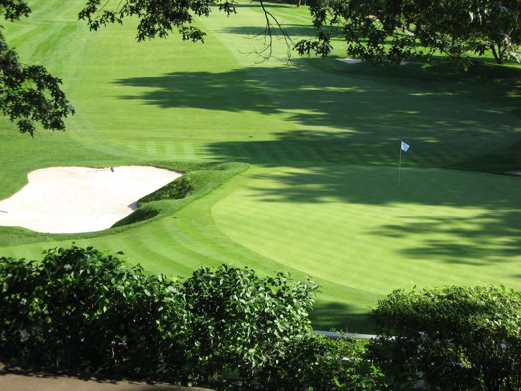 Panoramic view of a lush green golf course at Blue Hill Country Club. Smooth