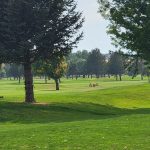 Panoramic view of a lush green golf course at Boise Ranch Golf Course. Smooth