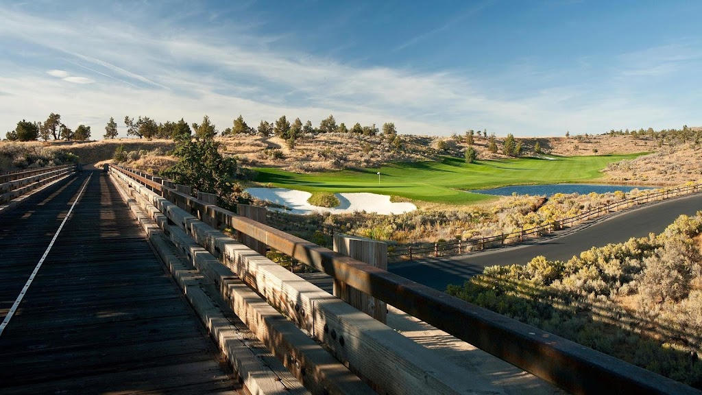 Panoramic view of a lush green golf course at Brasada Canyons. Smooth