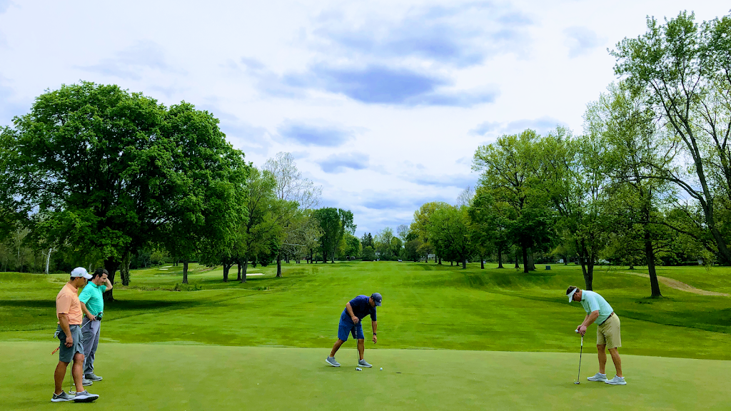 Panoramic view of a lush green golf course at Broadmoor Country Club. Smooth