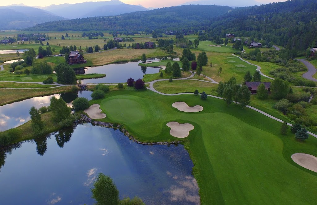 Panoramic view of a lush green golf course at Bronze Buffalo Ranch at Teton Springs. Smooth