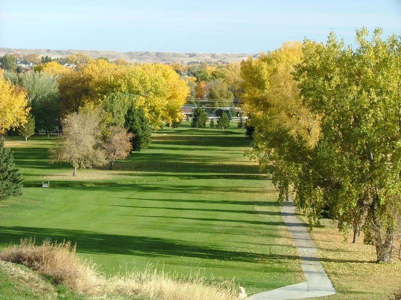 Panoramic view of a lush green golf course at Buffalo Golf Club. Smooth