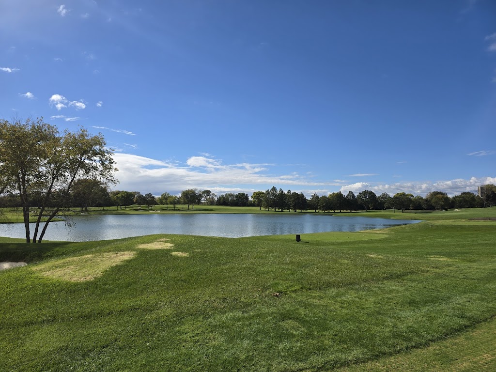 Panoramic view of a lush green golf course at Butler National Golf Club. Smooth