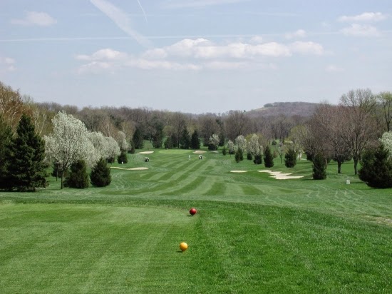 Panoramic view of a lush green golf course at Butler's Golf Course. Smooth