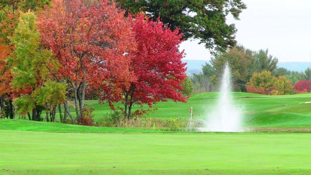 Panoramic view of a lush green golf course at Campbell's Scottish Highlands Golf Course & Driving Range. Smooth