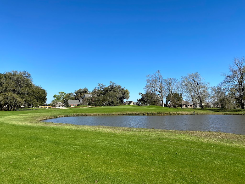 Panoramic view of a lush green golf course at Cane Row Golf & Turf Club. Smooth