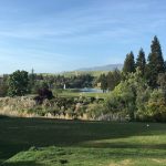 Panoramic view of a lush green golf course at Canyon Lakes Golf Course. Smooth