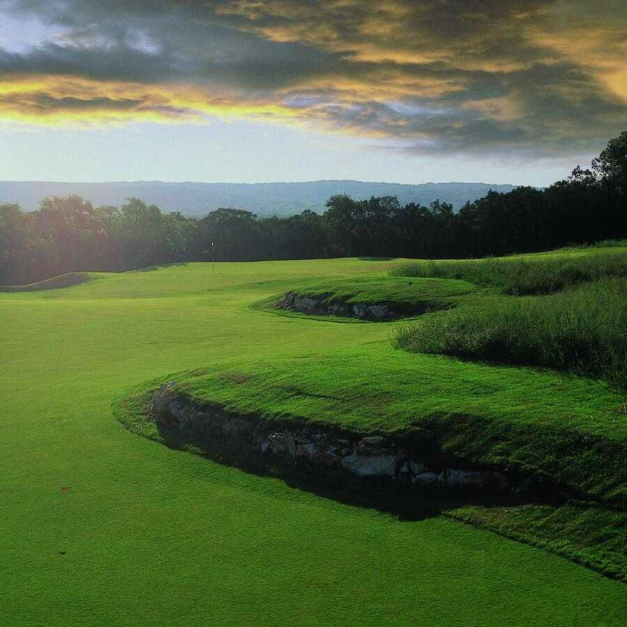 Panoramic view of a lush green golf course at Canyon Springs Golf Club. Smooth