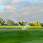 Panoramic view of a lush green golf course at Cardinal Hills Golf Course. Smooth