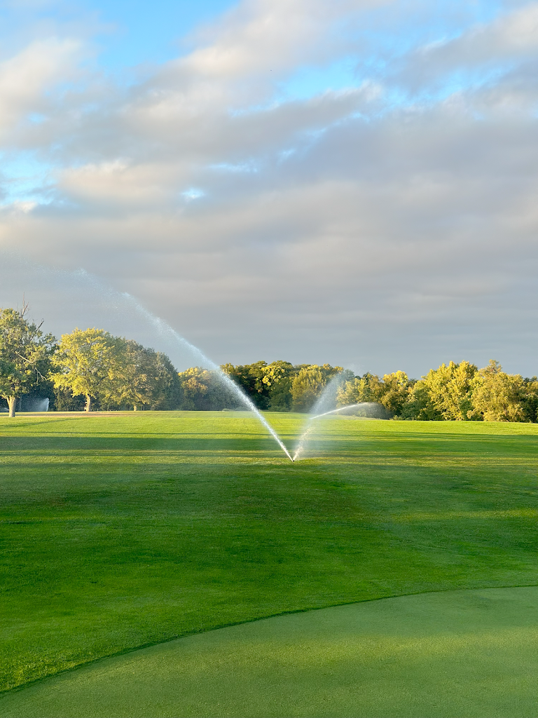 Panoramic view of a lush green golf course at Cardinal Hills Golf Course. Smooth