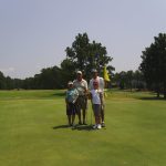 Panoramic view of a lush green golf course at Carolina Lakes Golf Course. Smooth