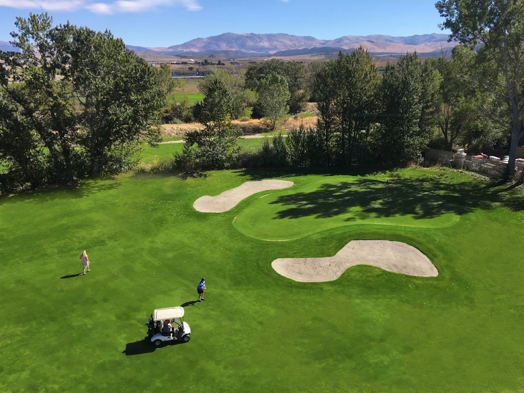 Panoramic view of a lush green golf course at Carson Valley Golf Course. Smooth