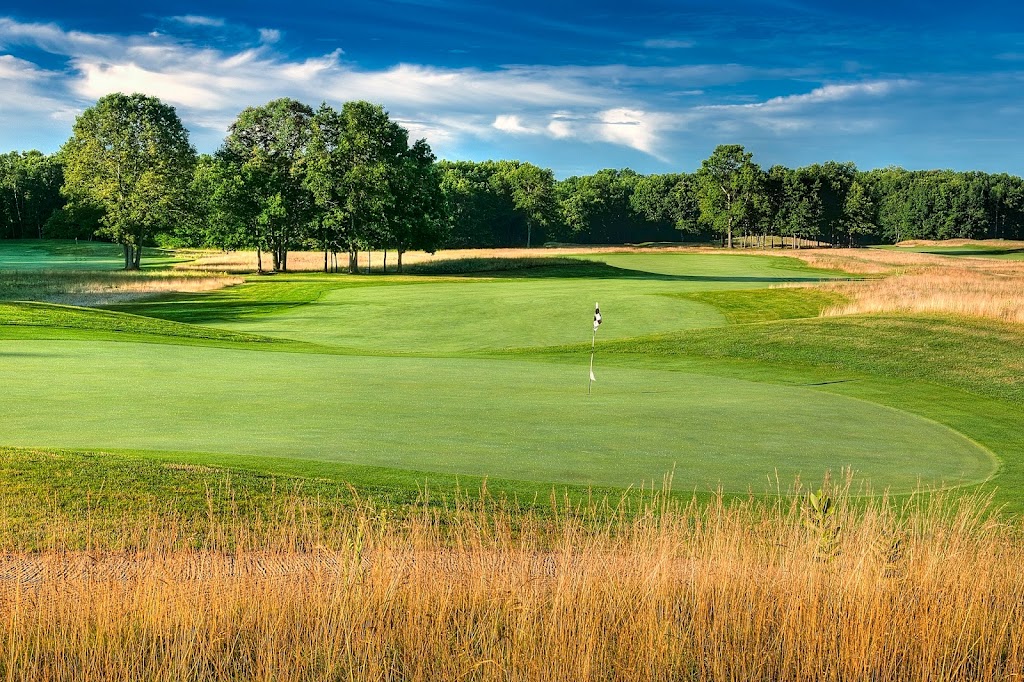 Panoramic view of a lush green golf course at Cedar Chase Golf Club. Smooth