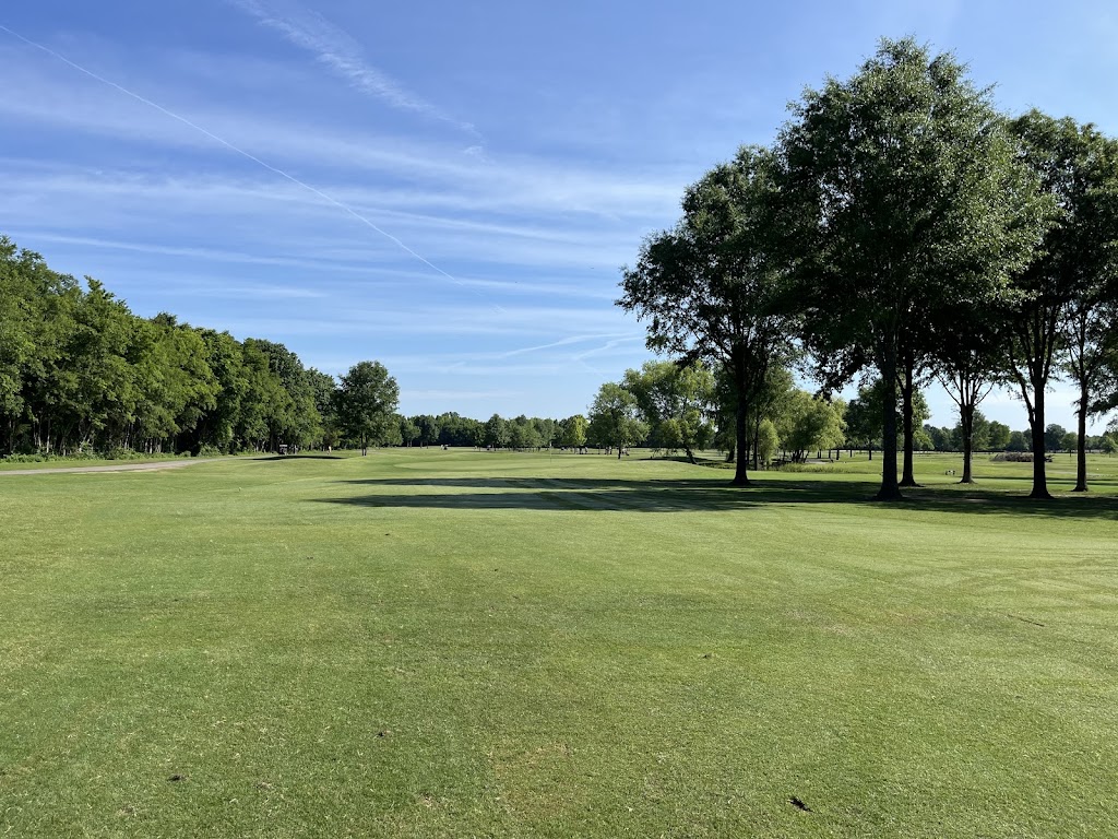 Panoramic view of a lush green golf course at Champions Run Golf Course. Smooth